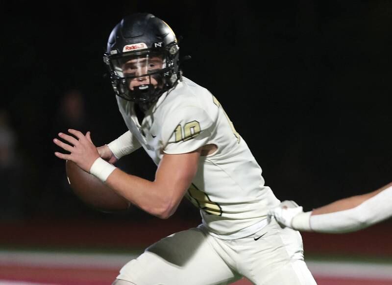 Sycamore's Burke Gautcher avoids a Morris pass rusher during their game Friday, Oct. 20, 2023, at Morris High School.