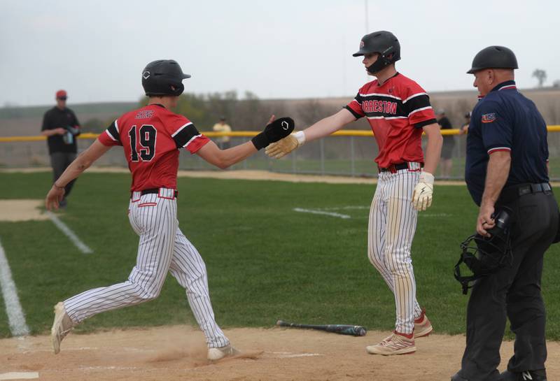 Forreston's Brendan Greenfield (right) greets Carson Akins at home plate during a Monday, April 28, 2025 game with Lena-Winslow at Forreston High School.