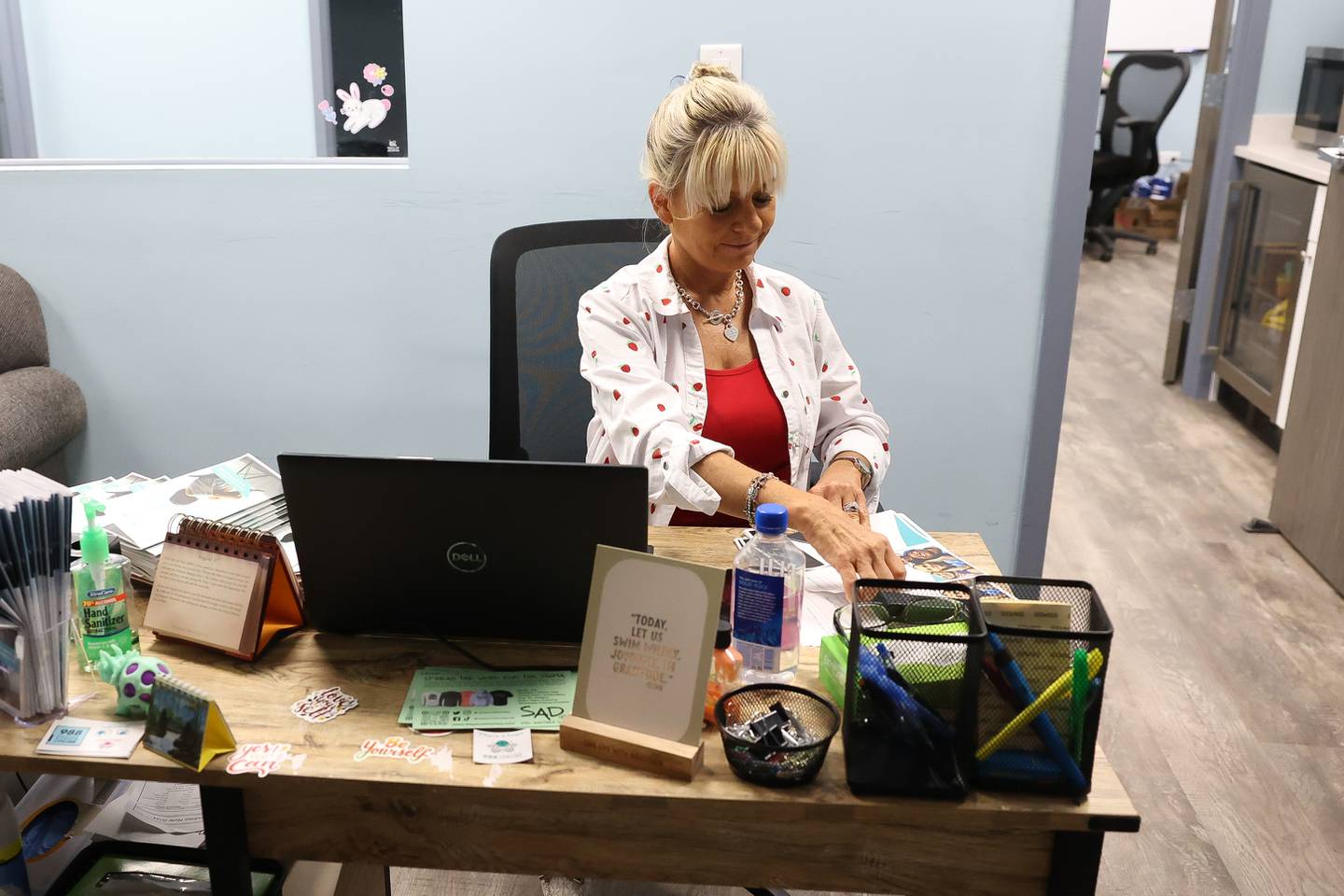 Victoria Menard works on informative pamphlets while working the front dest at The Living Room on Wednesday, May 15, 2024 in Joliet.
