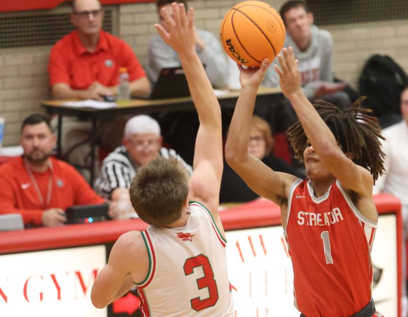 Streator's Layzeric Moton shoots a jump shot over L-P's Braylin Bond during the Dean Riley Shootin' The Rock Thanksgiving Tournament on Monday Nov. 24, 2025 in Kingman Gymnasium at Ottawa High School.