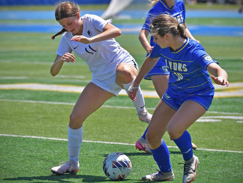 Downers Grove North’s Jordyn Sashin (11) and Lyons Township’s Abby McKenna go for the ball during their Class 3A Lyons Regional final on May 23, 2026 at Lyons Township High School in LaGrange.