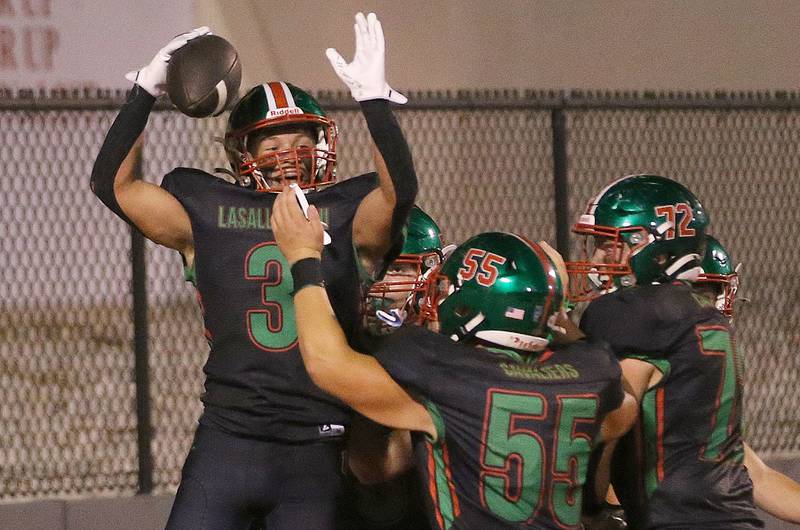 L-P's Rylynd celebrates with teammates Gus Konieczki and Brady Twardowski celebrate after scoring a touchdown against Ottawa on Friday, Oct. 3, 2025 at Howard Fellows Stadium.