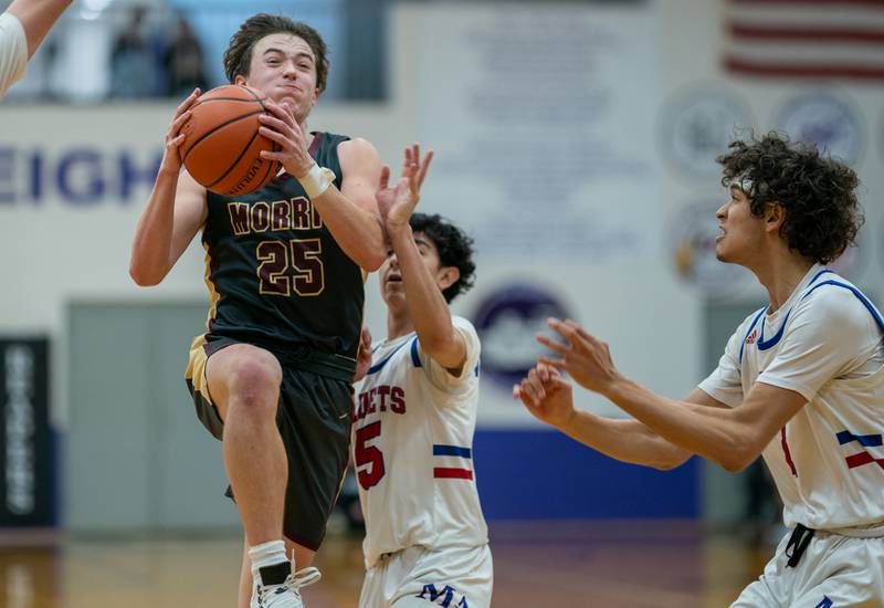 Morris’ Brett Bounds (25) drives to the hoop against Marmion's Jacob Piceno (5) during the 59th Annual Plano Christmas Classic basketball tournament at Plano High School on Tuesday, Dec 27, 2022.