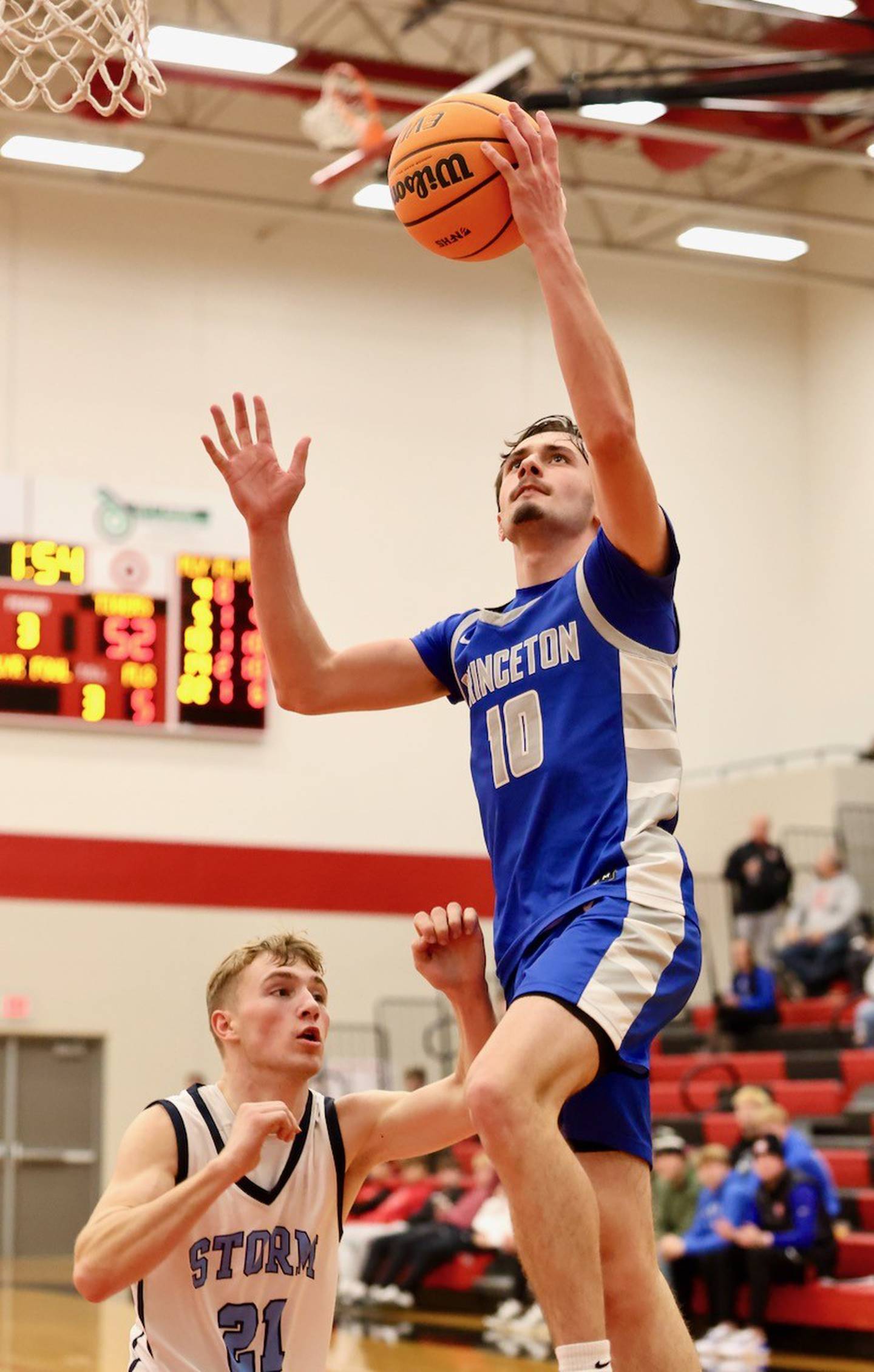 Princeton's gavin Lanham takes in a layup against Bureau Valley's Zac Wiggim in Saturday's Colmone Classic action at Hall High School. The Tigers won 86-83 in double overtime.