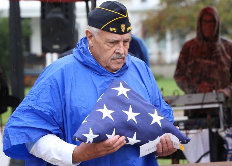 Vern Sondgeroth, Commander of the American Legion Veterans Post #180 carries a American Flag during a Civil War Monument Ceremony on Friday, Sept. 22, 2023 outside the Sash Stalter Matson Building in Princeton. The memorial honors 45 black troops who lived in Bureau County and fought in the Civil War.