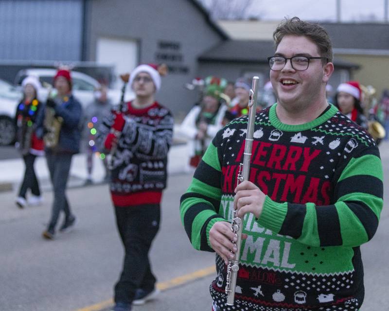 LaSalle Peru High School band member Carl Hicks marches with his flute during the Oglesby Winter Parade on December 9, 2023.
