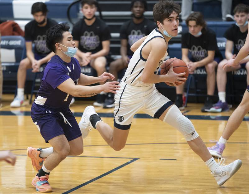Cary-Grove's John Mau gets past Hampshire defender Kevin Dela Paz during their game on Tuesday, January 25, 2022 at Cary-Grove High School in Cary.