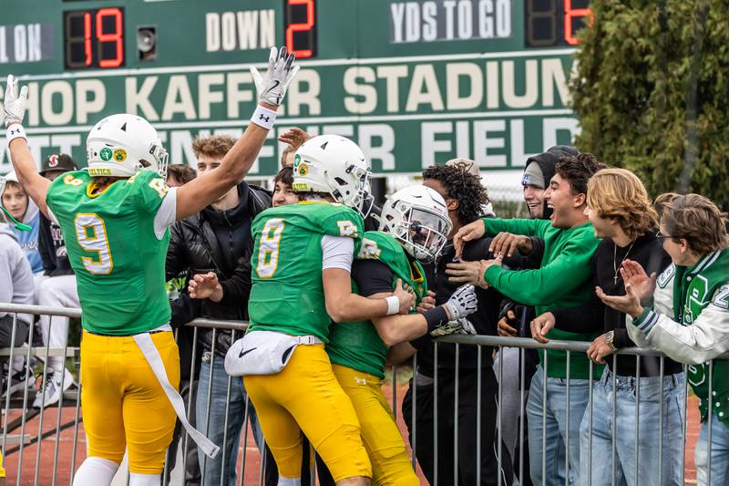 Providence's Bryaden McKay celebrates with fans and teammates after scoring a touchdown during a 5A varsity football semifinal game against Oak Forest at Providence Catholic High School on Nov. 22, 2025.