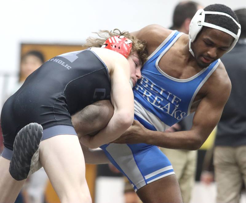 Woodstock’s Taqiuldin Baker, right, battles Marian’s Cam Spiniolas at 126 pounds in boys wrestling IHSA Class 2A Regional championship bout action on Saturday, Jan. 31, 2026, at Harvard High School in Harvard.