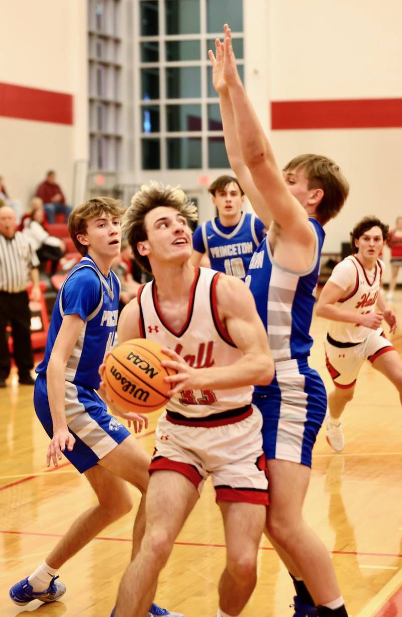 Hall's Braden Curran eyes the basket on Princeton's Arthur Burden at the Colmone Classic on Friday night.