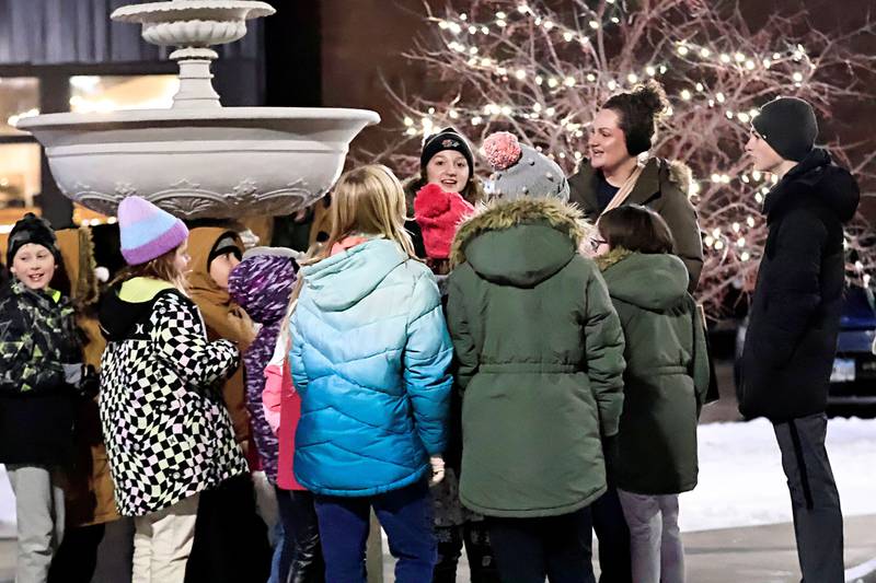 Erie High School choir teacher Kate Leising led the children in some Christmas carols on Saturday after the annual Christmas Parade in Erie.