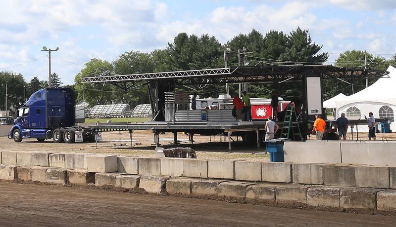 Volunteers set up a large stage on Wednesday, Aug. 20, 2025 at the Bureau County Fair in Princeton. Trace Atkins will headline the 170th annual fair on Thursday.