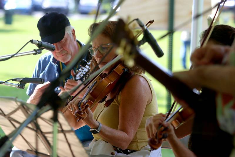 Members of the Plank Road Folk Music Society perform during the Fox Valley Folk Music & Storytelling Festival at Wheeler Park in Geneva on Sunday, August 31, 2025.