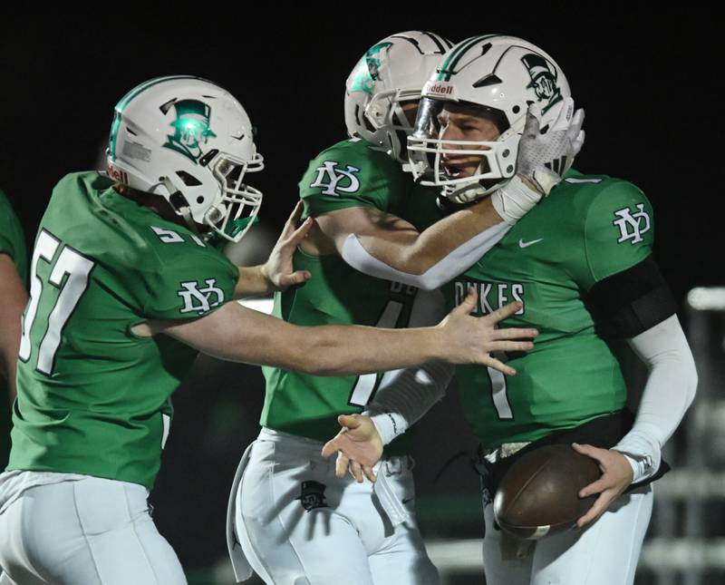 York’s Bruno Massel, right, celebrates a first-quarter touchdown with teammates Jack Bodach, left, and Fintan Helm during a Class 8A football quarterfinal on Friday, Nov. 15, 2024 in Elmhurst.