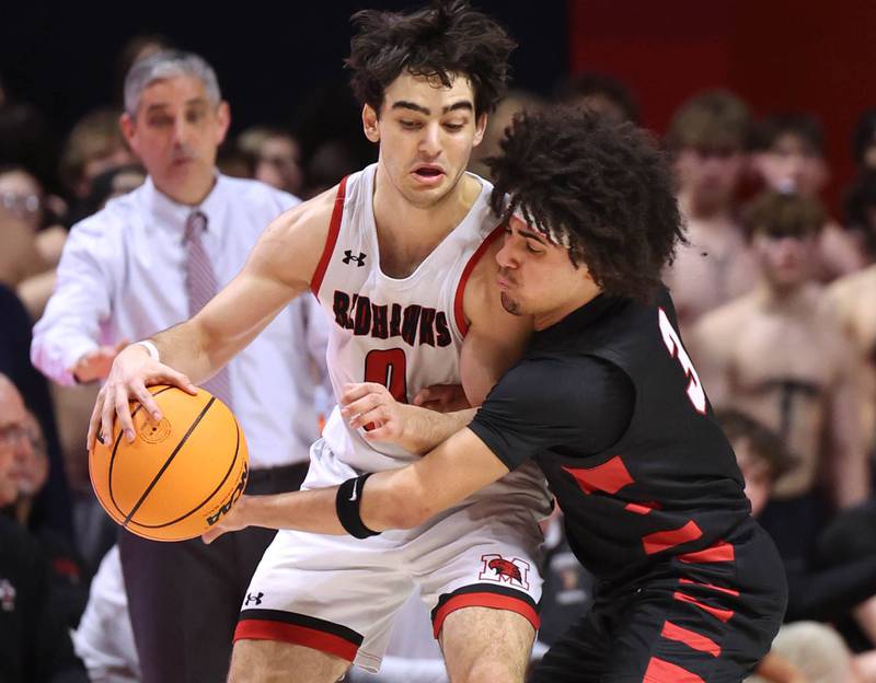 Benet's Jayden Wright tries to steal the ball from Marist's Adoni Vassilakis Saturday, March 14, 2026, during their IHSA Class 4A state championship game in the State Farm Center at the University of Illinois in Champaign.