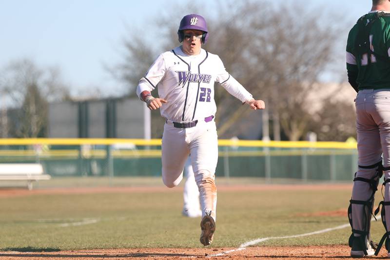 Joliet Junior College’s Cooper Hertz scores on a Brendan Sturm single against Moraine Valley on Tuesday, March 7th, 2023.