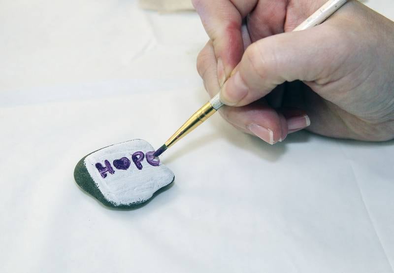 Sabrina Nieves, of Ingleside paints a positive message titled, "Hope," on a rock to place in the neighborhood to make someone's day during the Live 4 Life’s 9th Annual Day of Hope at the Community Center on September 17th in Fox Lake.
Photo by Candace H. Johnson for Shaw Local News Network