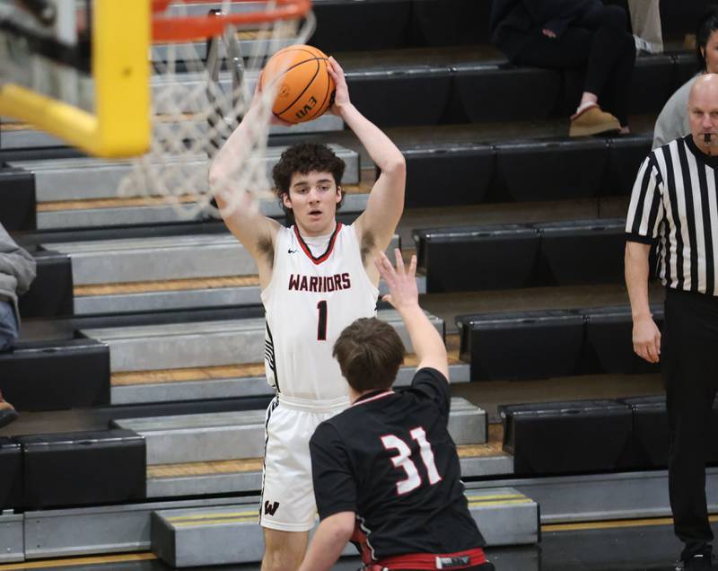 Woodland's Brezdyn Simons looks to pass over Henry-Senachwine's Evan Culp during the Tri-County Conference Tournament on Monday, Jan. 26, 2026 at Putnam County High School