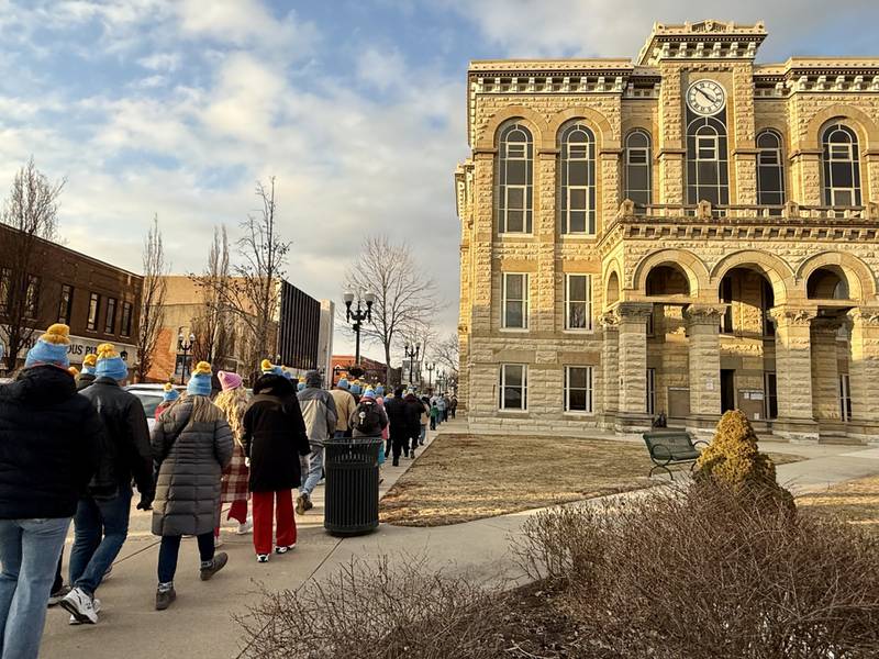 A group of walkers moves along the route during the "Coldest Night of the Year" mile-long walk Saturday night at Jordan Block Park in downtown Ottawa. The event featured more than 110 walkers representing 18 teams.