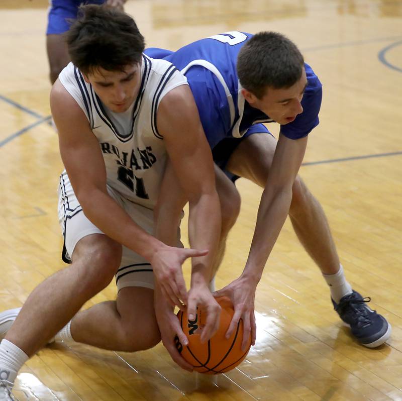 Cary-Grove's Brady Elbert battle with Burlington Central's Patrick Magan for a loose ball  during a Fox Valley Conference  boys basketball game on Wednesday Jan. 7,  2026, at Cary-Grove High School, in Cary.