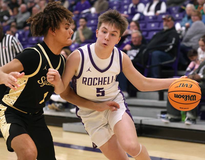 Rochelle's Mason Ludwig drives against Sycamore's Josiah Mitchell Friday, Dec. 5, 2025, during their game at Rochelle High School.