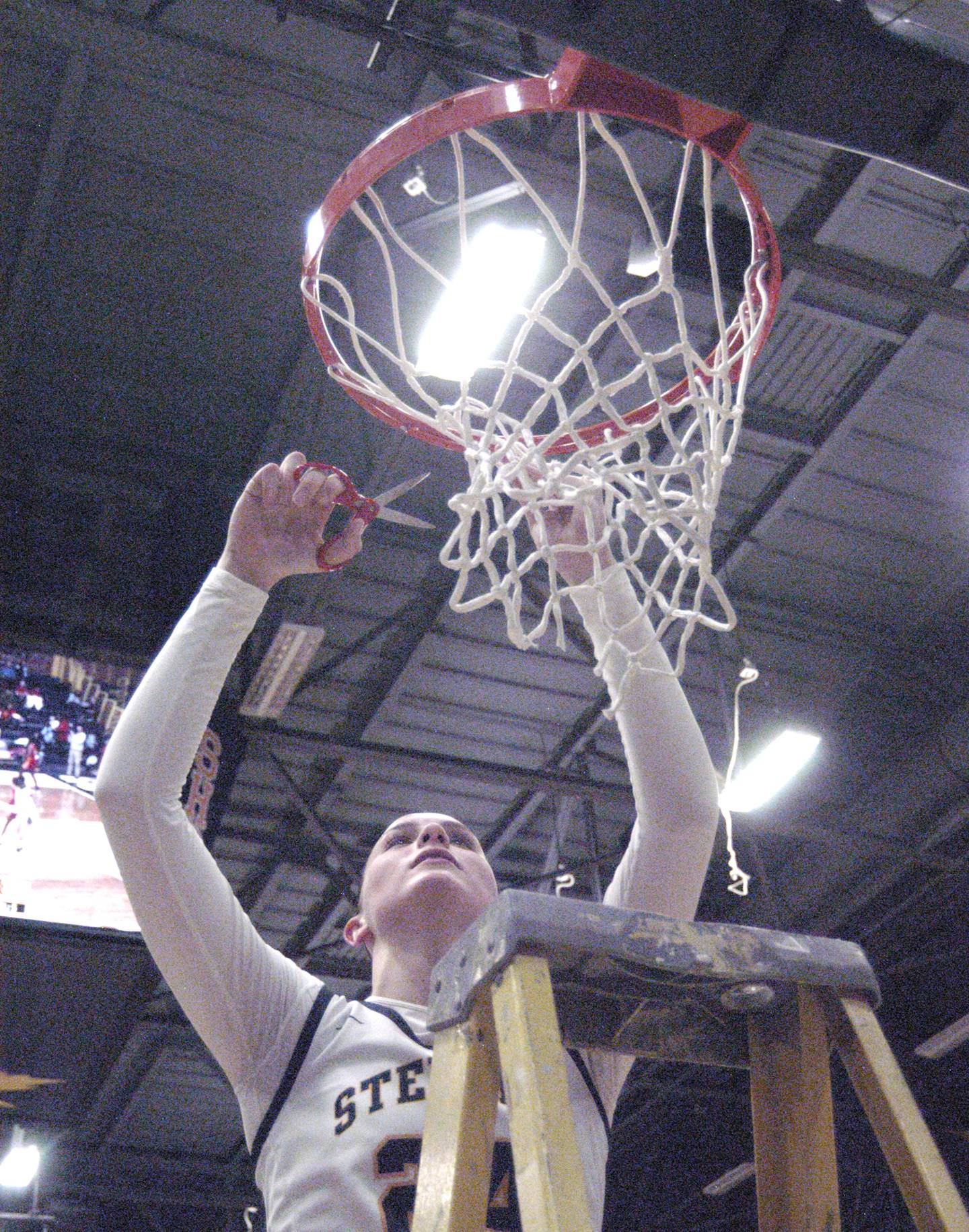 Sterling's Madison Austin cuts a piece of the net. The Sterling Golden Warriors faced off against Plano Lady Reapers in an IHSA 3A Regional girls final at Musgrove Fieldhouse in Sterling on February 20, 2025. Sterling won the game 70-38.