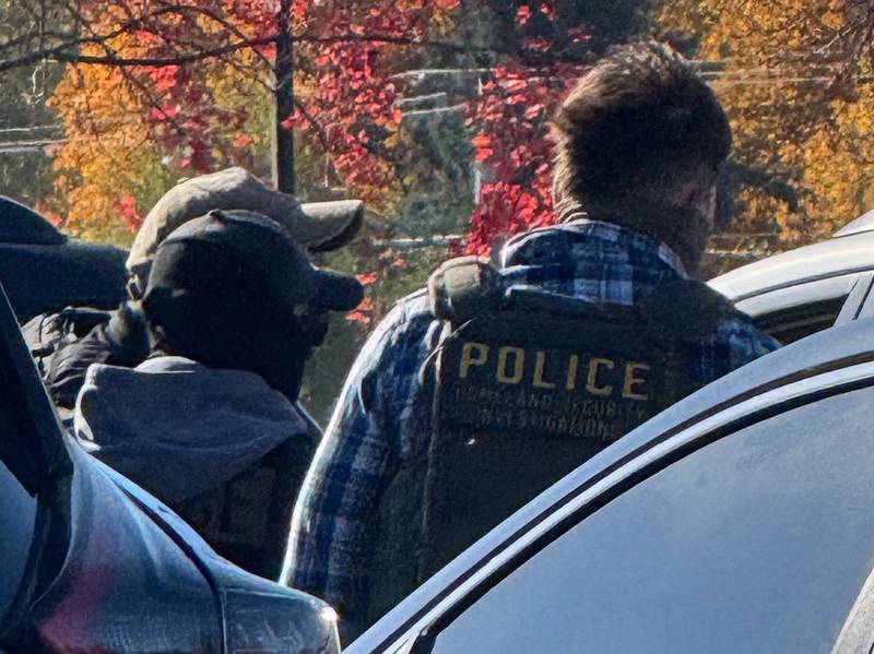 Agents wearing masks and vests that say Homeland Security take a man into custody outside the McHenry County courthouse in Woodstock on Wednesday, Nov. 5, 2025. Eye witnesses said the officers smashed the door of a car to detain the man.
