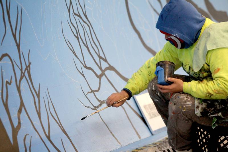 Artist Juan De La Mora works on his mural in the Taylor Avenue pedestrian underpass in Glen Ellyn on Wednesday, Nov. 16, 2022. De La Mora’s piece will feature the four seasons as you progress through the tunnel.