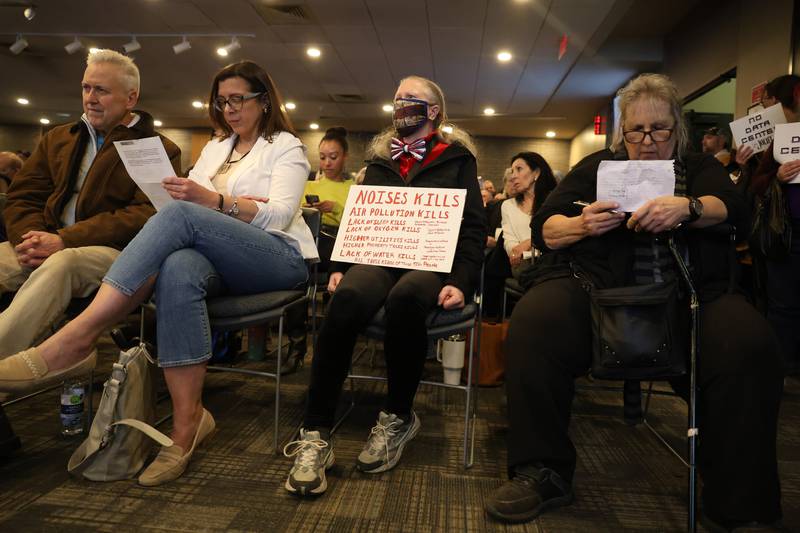 Resident holds custom sign against the proposed Data Center at the City of Joliet Plan Commission meeting on Thursday, March 5, 2026 in Joliet.