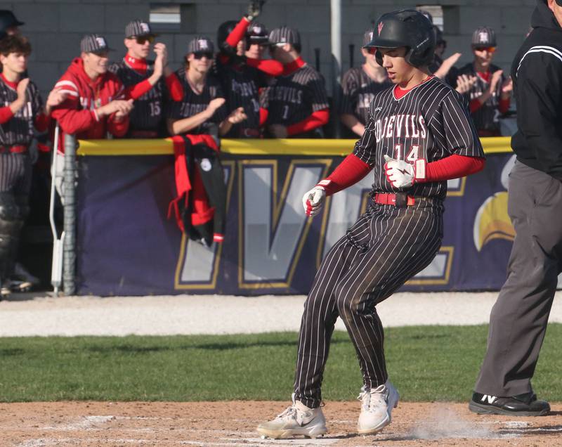 Hall's Geno Ferrari steps on home plate to score the teams first run on Monday, March 31, 2025 at Schweickert Stadium in Peru.