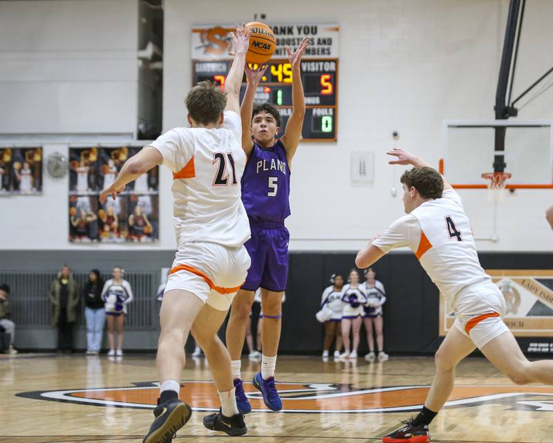 Plano's Eric Nunez (5) shoots a three point shot during their basketball game between Sandwich at Plano Tuesday, Jan 27, 2026 in Sandwich.