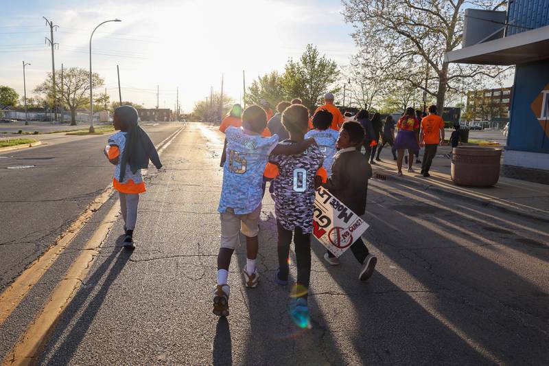 Two young participants walk arm in arm as they near the end of the 2nd Walk Against Gun Violence in Kankakee on Tuesday, April 29, 2025. The young residents carried signs opposing gun violence they made in art class.