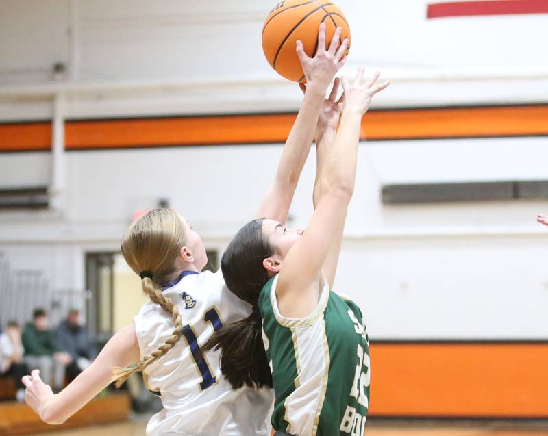 St. Bede's Bailey Engels and Marquette's Keeley Nelson go after a rebound during the Tri-County Conference championship game on Thursday, Jan. 23, 2025 at Roanoke-Benson High School.