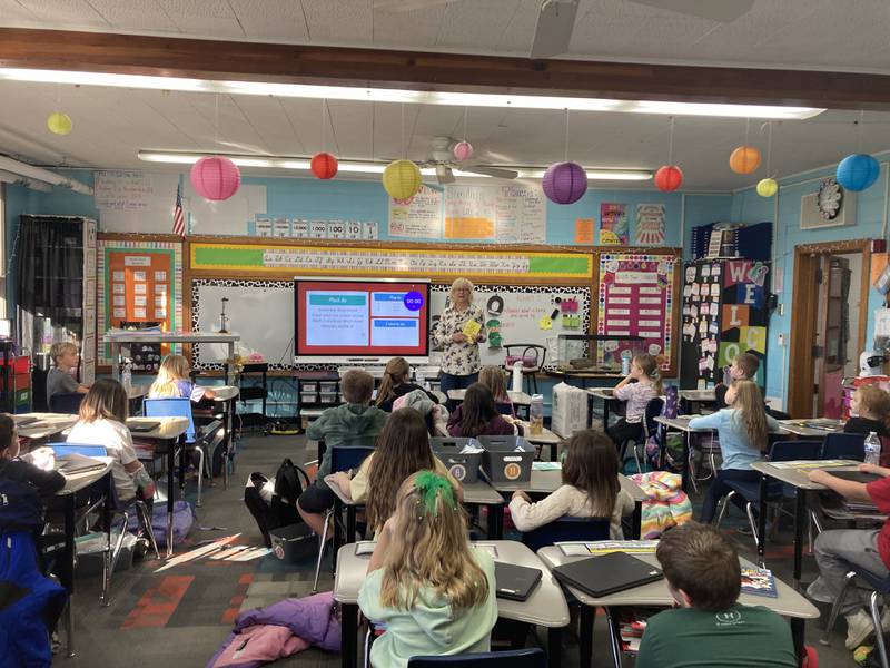 Rock Falls Rotarian Cheryl Faber is shown in a third-grade classroom at East Coloma-Nelson, where dictionaries were presented during American Education Week.