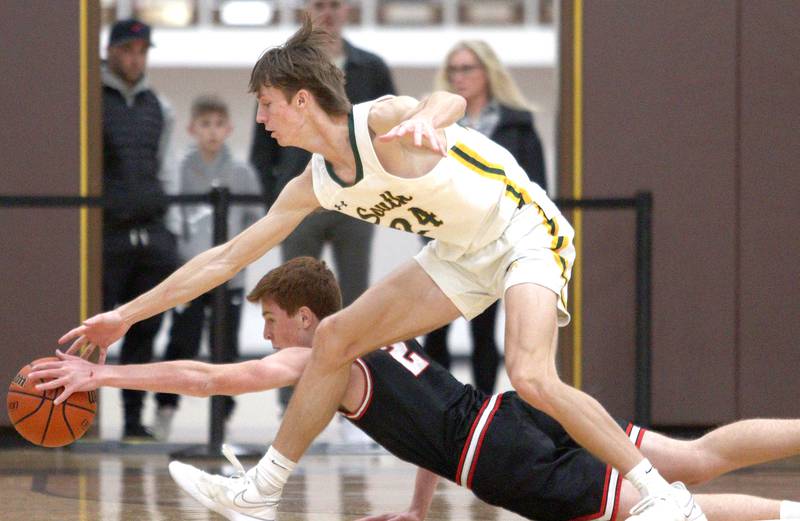 Crystal Lake South’s  James Carlson, top and Barrington’s Adam Baird pursue the ball in Hinkle Holiday Classic boys basketball tournament game action at Jacobs High School Tuesday.