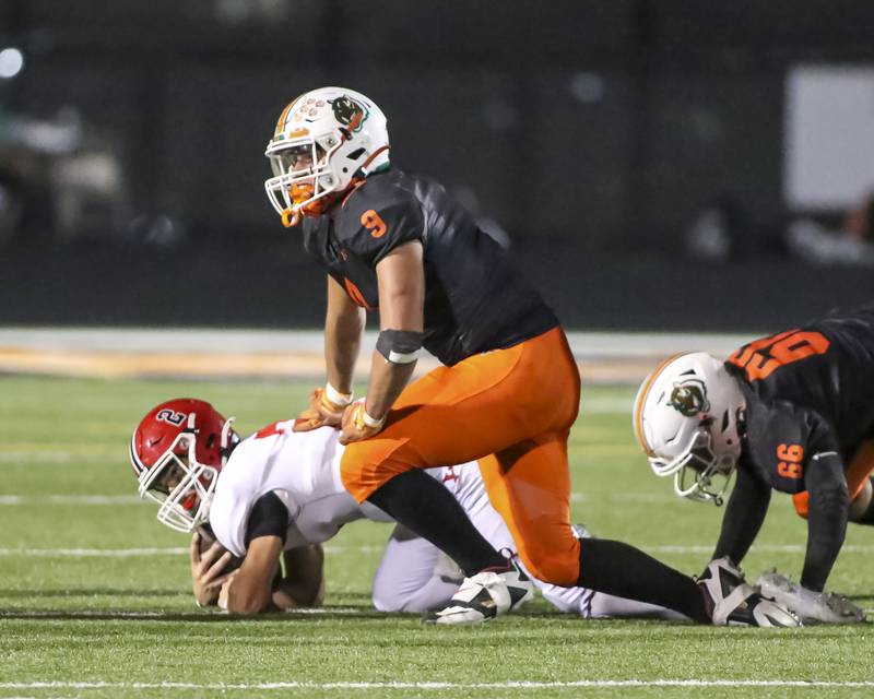 Plainfield East's Colin Dominiak (9) sacks Yorkville's Jack Beetham (2) during football game between Yorkville at Plainfield East Friday, Sept 19, 2025 in Plainfield.