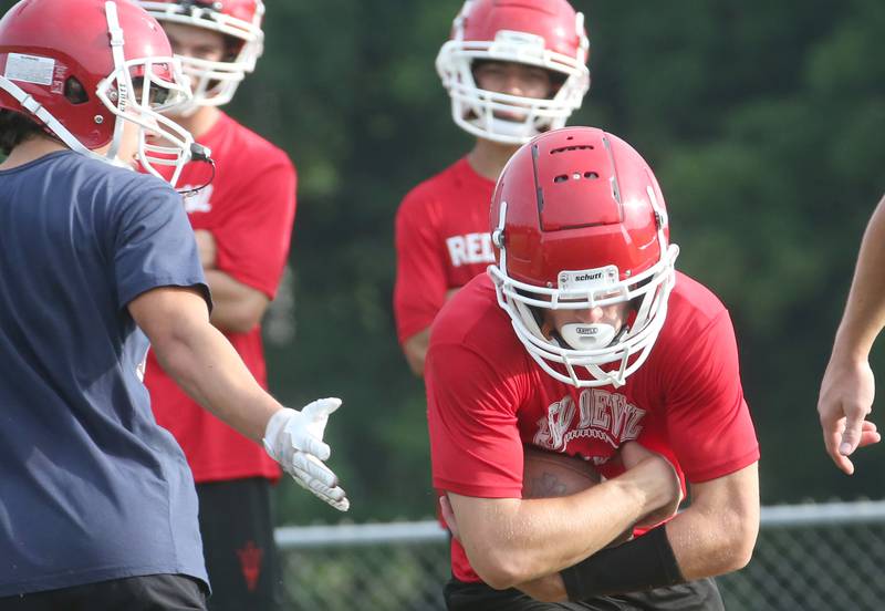 Hall's Braden Curran runs with the ball during camp on Thursday, July 24, 2025 at Hall High School.