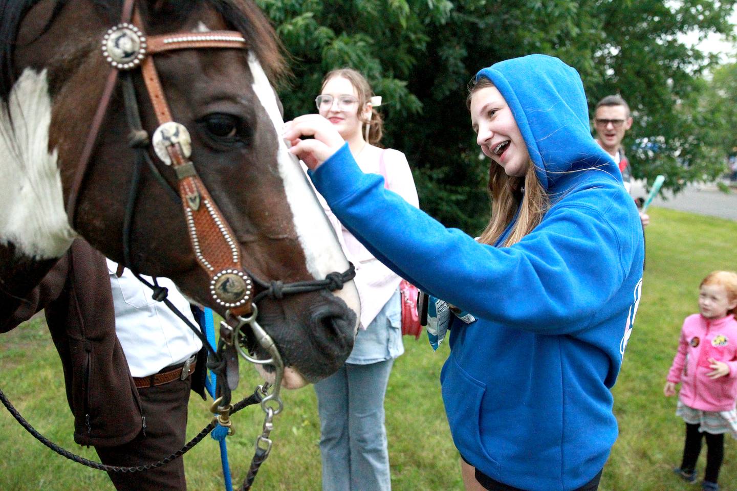 Emily Hern, 13, of St. Charles pets the nose of Kane County Rangers horse Shiloh as Evelyn Hern, 16, (left) looks on duirng the Kane County Sheriff’s National Night Out in St. Charles on Tuesday, Aug. 6, 2024.