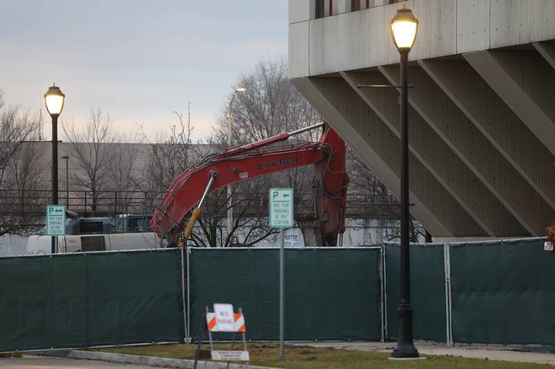 Fencing is put up around the old courthouse and equipment is brought in preparation for demolition in downtown Joliet on Tuesday, Dec. 5, 2023.