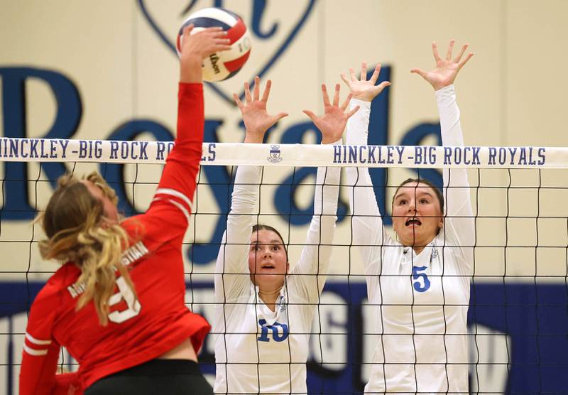Hinckley-Big Rock’s Madaline Hogan (left) and ILY Hunt try to block a spike during their match against Aurora Christian Tuesday night at the school in Hinckley.
