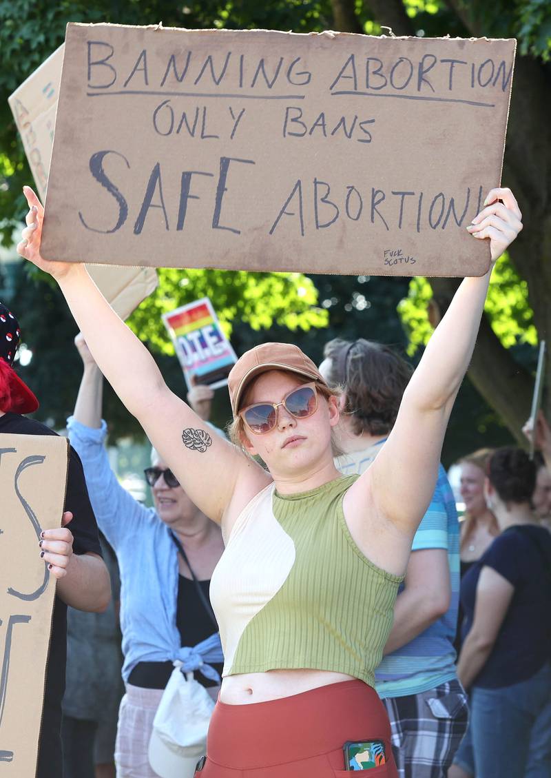A protester holds a sign Friday, June 24, 2022, during a rally for abortion rights in front of the DeKalb County Courthouse in Sycamore. The group was protesting Friday's decision by the Supreme Court to overturn Roe v. Wade, ending constitutional protections for abortion.