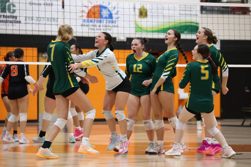 Teammates celebrate a kill by Grant Park's Taylor Panozzo, left, during the Dragon's loss in two sets, 25-22, 25-23, to Beecher in the RVC championship game on Monday, Oct. 20, 2025, at Beecher High School.