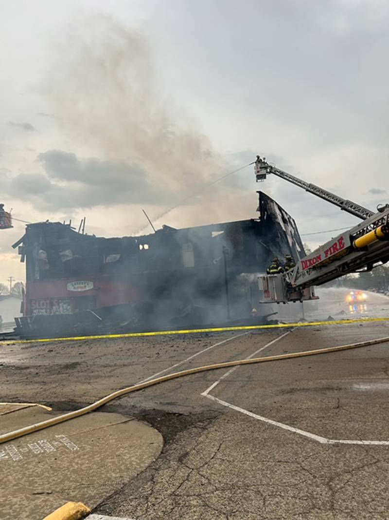 Dixon firefighters spray water on a fire that broke out Tuesday, April 16, 2024, at Sharky's in Mt. Morris.