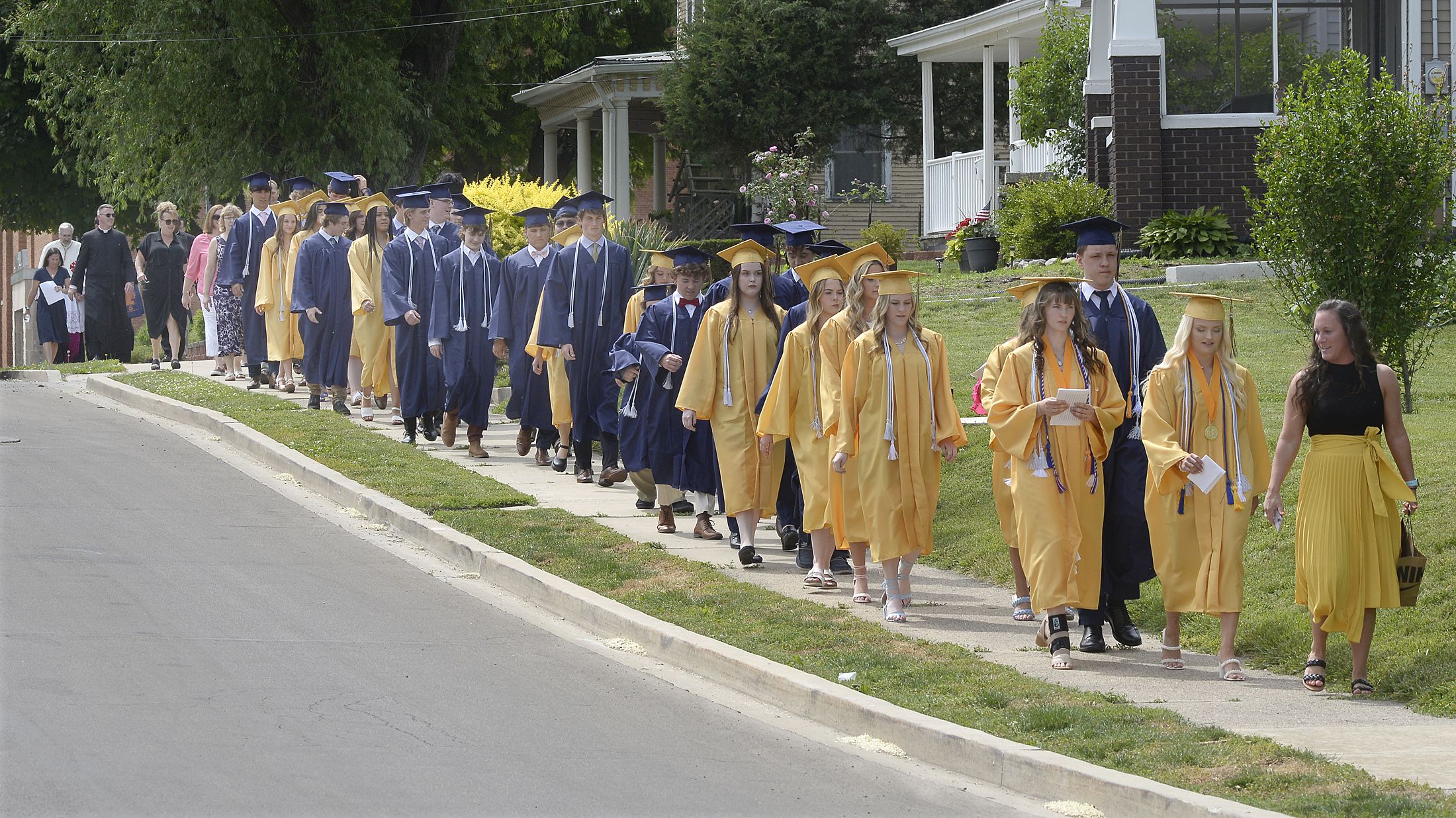The Marquette Academy Class of 2023 make their way down Lafayette Street to Gould Stadium for graduation ceremony Sunday, May 28, 2023.