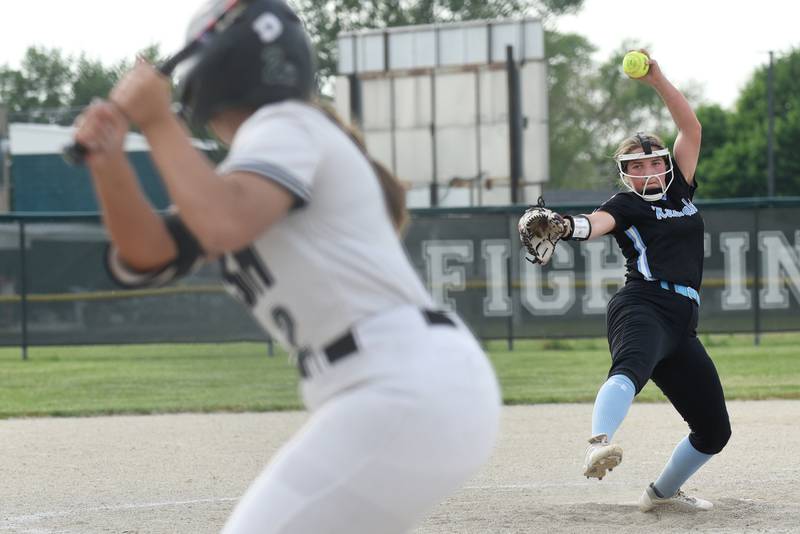 Kankakee's Kylie Glogowski, right, throws a pitch to Bishop McNamara's Bella DeLuca during a game at Bishop McNamara Tuesday, May 13, 2025.