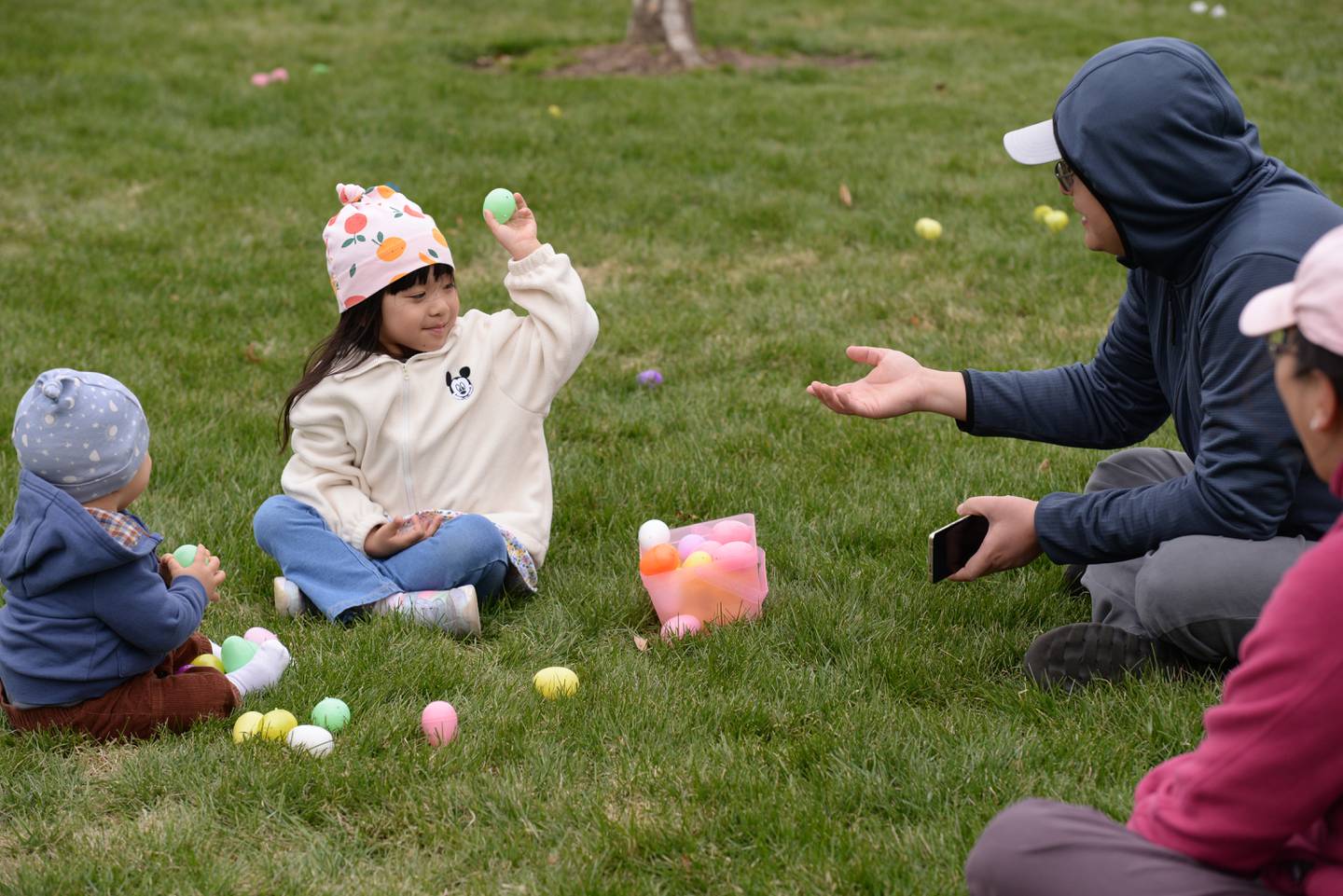 Shirley Gao of Naperville plays catch with her dad Yuan after during the Easter Egg Hunt held at Cantigny  Sunday April 13, 2025.