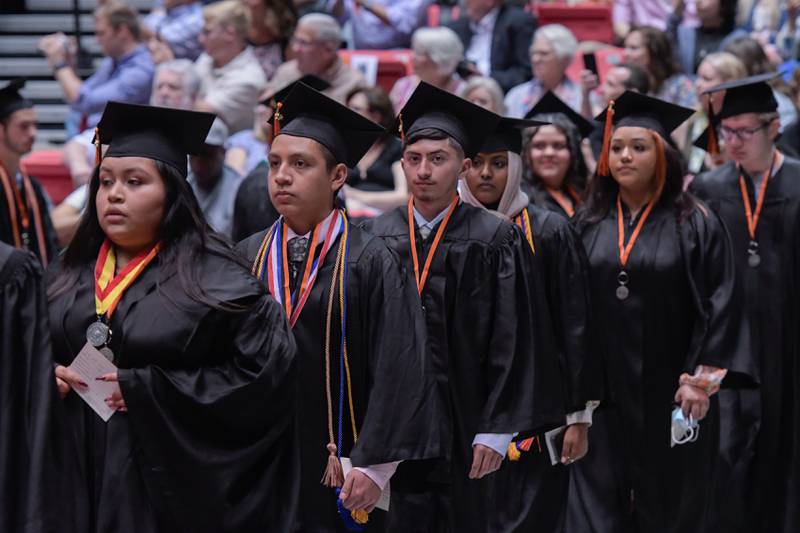 Graduates process in during the DeKalb High School graduation ceremony at the Convocation Center in DeKalb on Saturday, May 28, 2022.