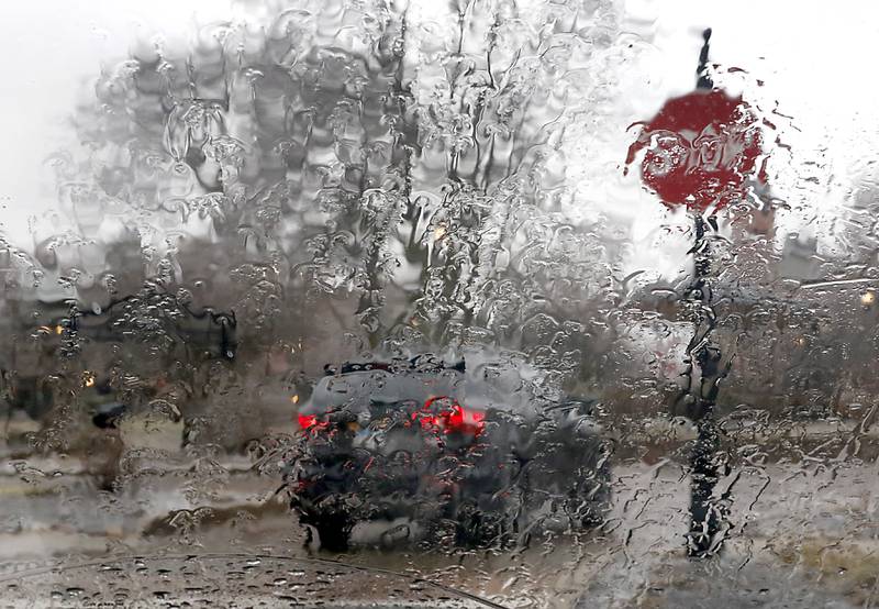 Ice and rain water distort the view through a car window as a motorist travels around the Woodstock Square on Wednesday, Feb. 22, 2023, as a winter storm that produced rain, sleet, freezing rain, and ice moved through McHenry County.