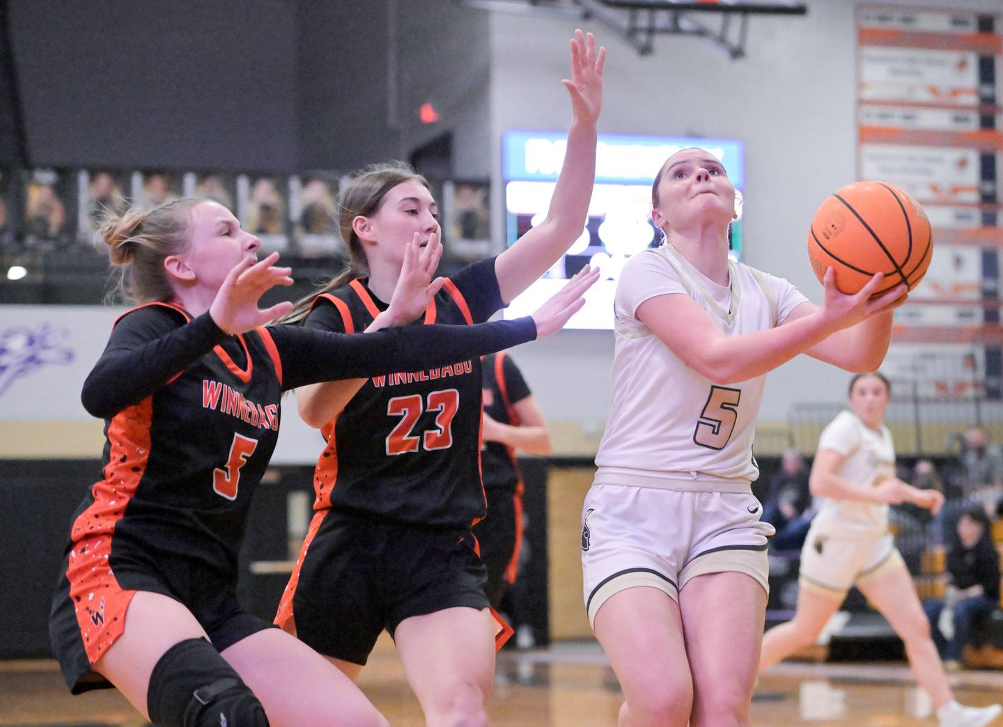 Sycamore's Grace Amptmann (5) takes a shot against Winnebago's Grace Corl (5) Ida Fager (23) during a game in Sycamore on Wednesday, Jan. 21, 2026.