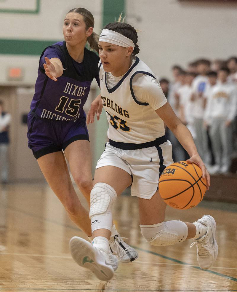 Sterling’s Joslynn James handles the ball against Dixon's Morgan Hargrove Thursday, Feb. 27, 2025, during the Class 3A girls Sectional title at Rockford Boylan High School.